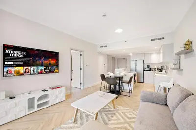 a living room with a couch and a table at Luxe 1BR in Fairways East with Canal Views in Dubai