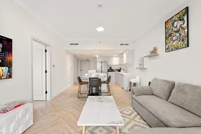 a living room with a couch and a table at Luxe 1BR in Fairways East with Canal Views in Dubai