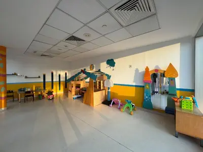 a large room with a play room with a play room at Luxe 1BR in Fairways East with Canal Views in Dubai