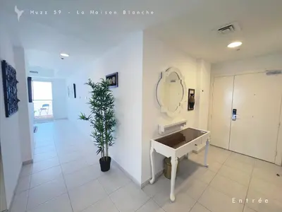 a bathroom with a sink and a potted plant at Huzz 59 - La Maison Blanche in Dubai