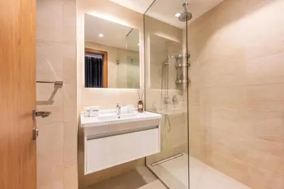 a bathroom with a sink and a shower at Exclusive Marina Stay - Posh 3BR with Stunning Views in Dubai