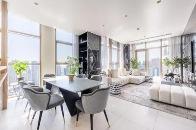 a living room with a table and chairs at Exclusive Marina Stay - Posh 3BR with Stunning Views in Dubai