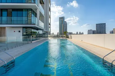 a swimming pool on the side of a building at Savis Home - Enjoy the City Skyline View 1BR in Binghatti Venus JVC in Dubai