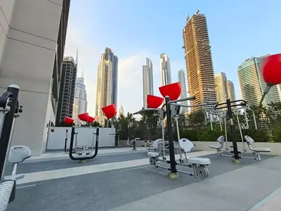 a row of exercise equipment on the roof of a building at Chic 2BR near Dubai Mall & Burj l Canal & City view I 5 pax in Dubai