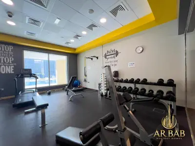 a fitness room with a gym with tread machines at Hamilton Residence - Luxury 1BR - Stunning Dubai Canal View - Near Dubai Mall & Burj Khalifa in Dubai