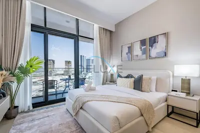 a bedroom with a large bed and a large window at Cozy Studio in Azizi Riviera 3, Al Merkadh by Deluxe Holiday Homes in Dubai