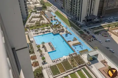an overhead view of a swimming pool in a city at Vogue Downtown Views II with Direct Access to Dubai Mall Via a Climate Controlled Bridge, Two Bedroom Apartment with Balcony and Burj Khalifa View in Dubai