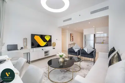 a living room with a couch and a table at Vogue Downtown Views II with Direct Access to Dubai Mall Via a Climate Controlled Bridge, Two Bedroom Apartment with Balcony and Burj Khalifa View in Dubai