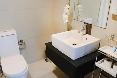 a bathroom with a white sink and a toilet at Cozy 1BHK Apartment-Dubai Marina in Dubai