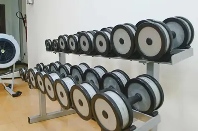 a row of dumbbells on a rack in a room at Cozy 1BHK Apartment-Dubai Marina in Dubai