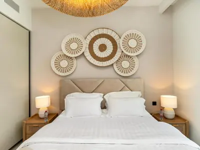 a bedroom with a bed with plates on the wall at Chic 1 Bedroom on Private Beach in Dubai Harbour in Dubai