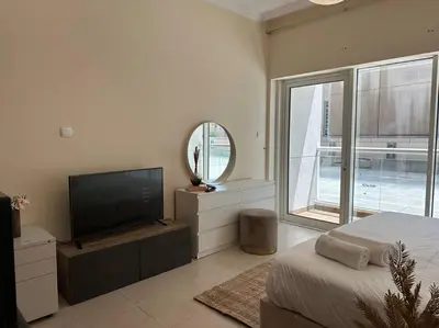 a bedroom with a bed and a tv and a mirror at Luxury Studio Near Burj Khalifa in Dubai