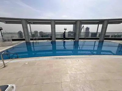 a large swimming pool on the roof of a building at Luxury Studio Near Burj Khalifa in Dubai