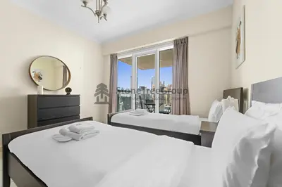 a hotel room with two beds and a mirror at High-floor 2BR at Palladium, JLT - Near Metro in Dubai