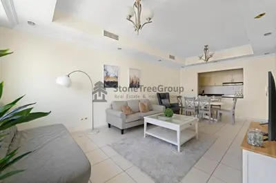 a living room with a couch and a table at High-floor 2BR at Palladium, JLT - Near Metro in Dubai