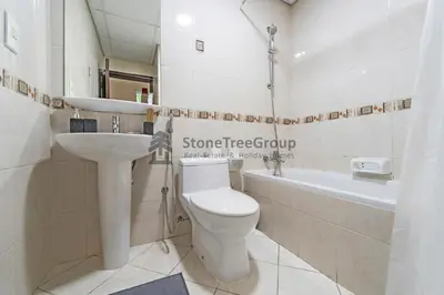 a bathroom with a toilet and a sink and a tub at High-floor 2BR at Palladium, JLT - Near Metro in Dubai