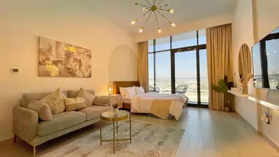 a living room with a couch and a bed at Luxury Interior Studio with Direct Burj Khalifa Views in the Heart of Dubai in Dubai