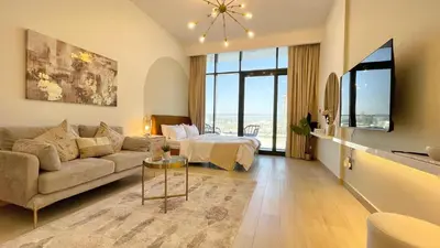 a living room with a couch and a bed at Luxury Interior Studio with Direct Burj Khalifa Views in the Heart of Dubai in Dubai
