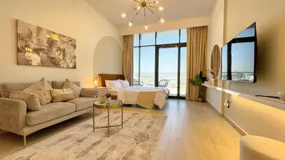 a living room with a couch and a bed at Luxury Interior Studio with Direct Burj Khalifa Views in the Heart of Dubai in Dubai