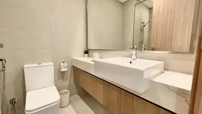 a bathroom with a sink and a toilet and a mirror at Luxury Interior Studio with Direct Burj Khalifa Views in the Heart of Dubai in Dubai