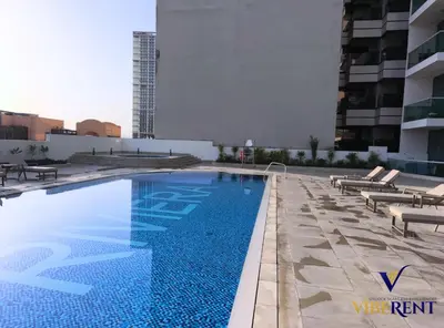 a swimming pool on the roof of a building at La Riviera Serenity in Dubai
