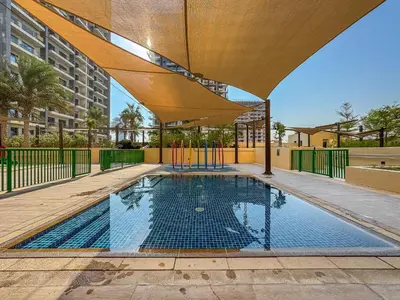 an empty swimming pool with a canopy over it at Urban Sanctuary Studio with Pool, Gym and Playground in Dubai