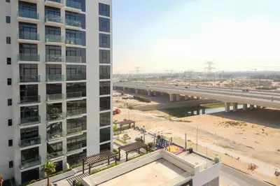 an overhead view of a bridge next to a building at NewArabian Azizi Riviera Studio in Dubai
