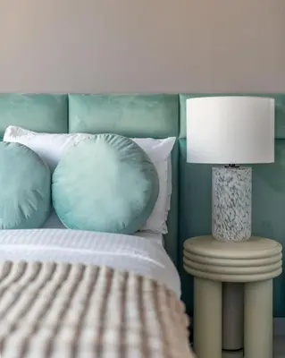 a bed with pillows and a lamp on a table at Stunning Burj Khalifa View 5 Star Hotel Amenities in Dubai
