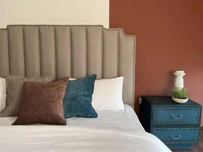 a bed with pillows and a table with a plant on it at Luxurious Meydan Dubai Villa with Unparalleled Views in Dubai