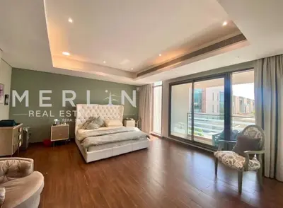 a living room with a couch and a large window at Luxurious Meydan Dubai Villa with Unparalleled Views in Dubai