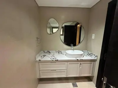a bathroom with a sink and a mirror at Luxurious Meydan Dubai Villa with Unparalleled Views in Dubai