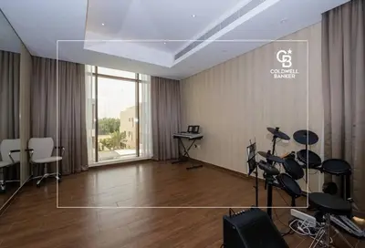 an empty room with a room with chairs and desks at Luxurious Meydan Dubai Villa with Unparalleled Views in Dubai