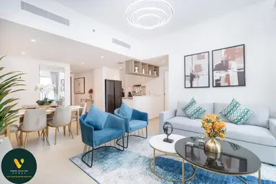 a living room with a couch and a table at Vogue Downtown Views II with Direct Access to Dubai Mall Via a Climate Controlled Bridge, Two Bedroom Apartment with Balcony and Burj Khalifa View in Dubai