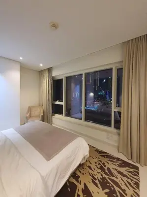 a bedroom with a bed and a large window at damac maison canal view Luxuary 1BHK in heart downtow in Dubai