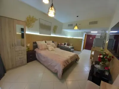 a bedroom with a large bed in a room at Cosy Studio Marina in Dubai