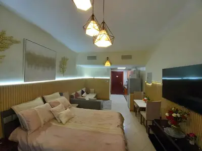 a bedroom with a bed and a living room at Cosy Studio Marina in Dubai