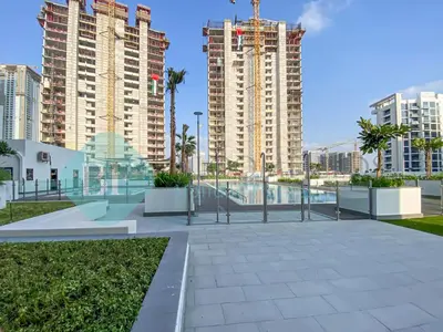 a walkway in a city with tall buildings at Bloomfields Modern Stu In Azizi Riviera in Dubai