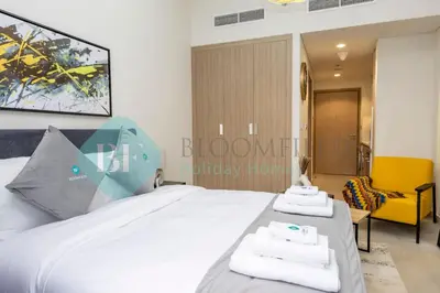 a bedroom with a bed with two towels on it at Bloomfields Modern Stu In Azizi Riviera in Dubai