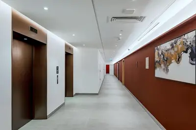 a hallway in a building with brown and white walls at La Mer 1bedroom Private Beach in Dubai