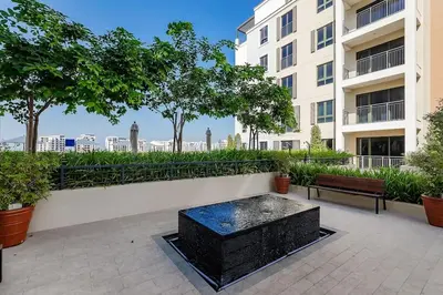 a fountain in a courtyard in front of a building at La Mer 1bedroom Private Beach in Dubai