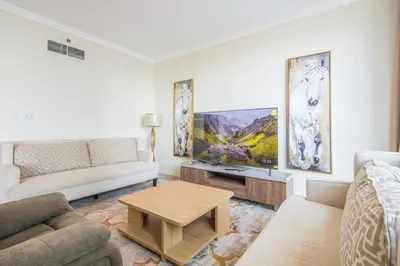 a living room with a couch and a table at Al Bateen Residences, JBR- Stunning 2-BR Apartment with Sea View in Dubai