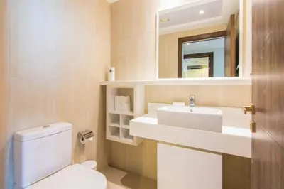 a bathroom with a toilet and a sink and a mirror at Al Bateen Residences, JBR- Stunning 2-BR Apartment with Sea View in Dubai