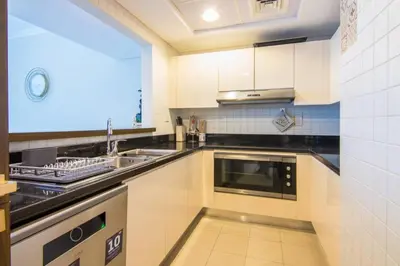 a kitchen with a sink and a microwave at Al Bateen Residences, JBR- Stunning 2-BR Apartment with Sea View in Dubai