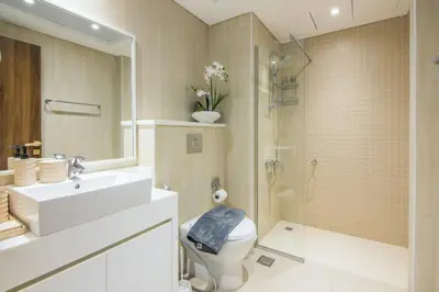 a bathroom with a sink and a toilet and a shower at Al Bateen Residences, JBR- Stunning 2-BR Apartment with Sea View in Dubai