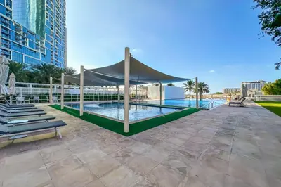 a canopy over a swimming pool in a building at Al Bateen Residences, JBR- Stunning 2-BR Apartment with Sea View in Dubai