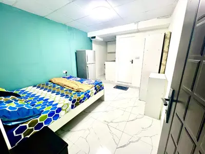 a bedroom with a bed and a blue wall at Flat in Dubai Al Karama in Dubai