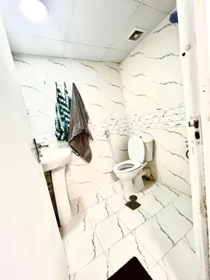 a bathroom with a toilet and a sink at Flat in Dubai Al Karama in Dubai
