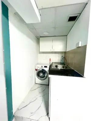 a kitchen with a washing machine and a sink at Flat in Dubai Al Karama in Dubai