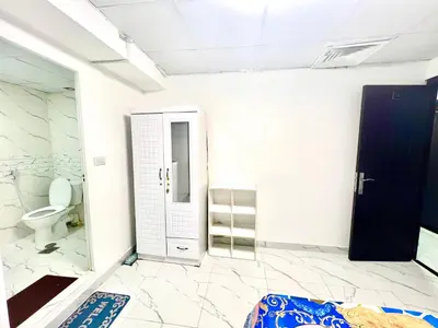 a bathroom with a toilet and a glass door at Flat in Dubai Al Karama in Dubai