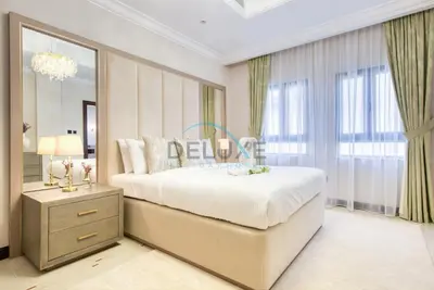 a bedroom with a large bed and a large window at Immaculate 4BR Villa with Assistant Room and Private Pool at Frond O Palm Jumeirah by Deluxe Holiday Homes in Dubai